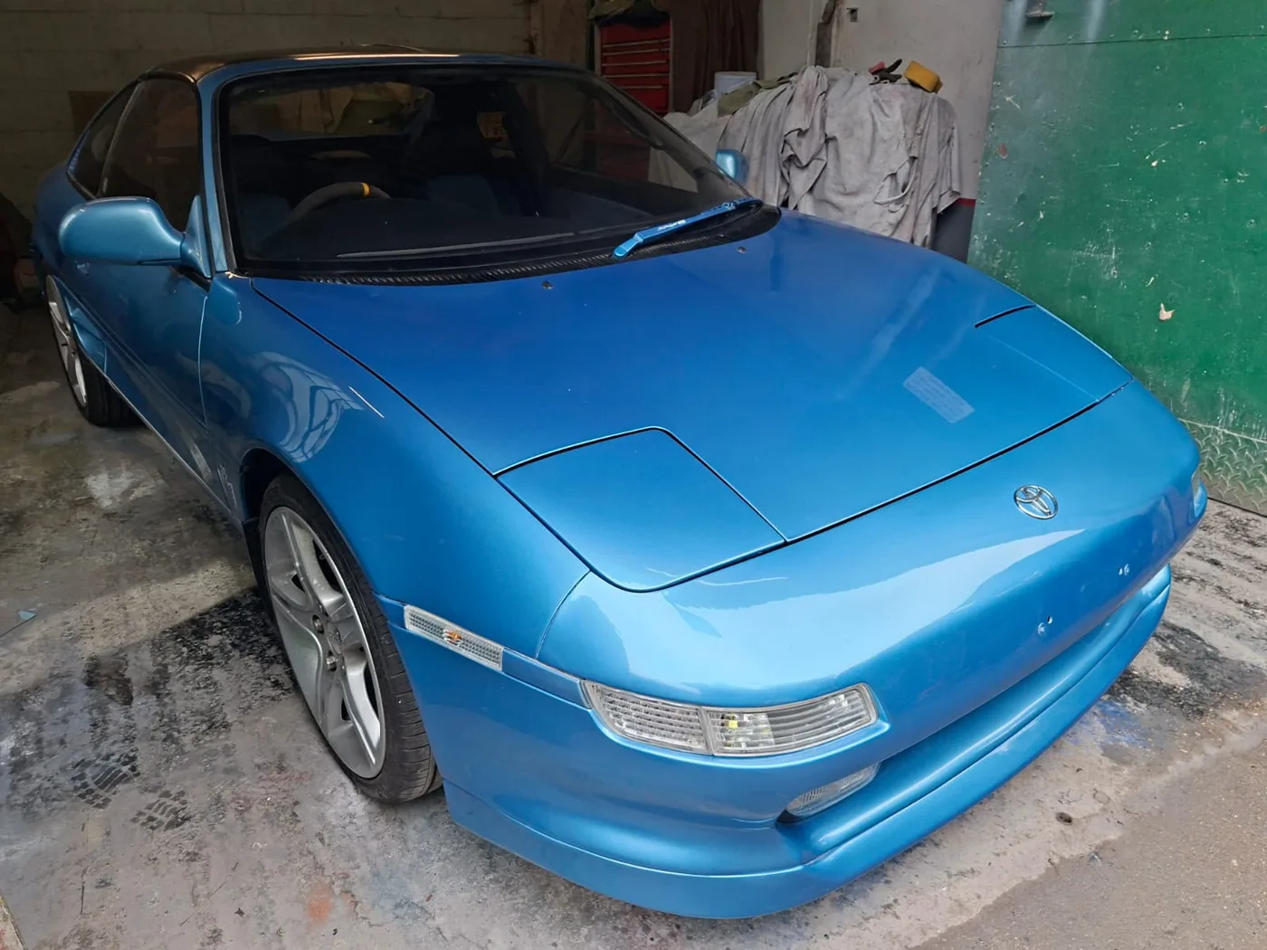 Classic sports coupe resprayed back to a deep, even blue gloss